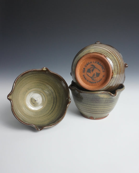 Two ceramic containers with textured surfaces on a gradient background