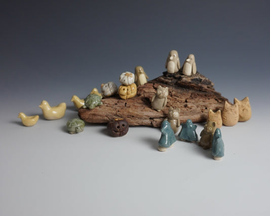 Decorative piece with small figurines on a textured surface